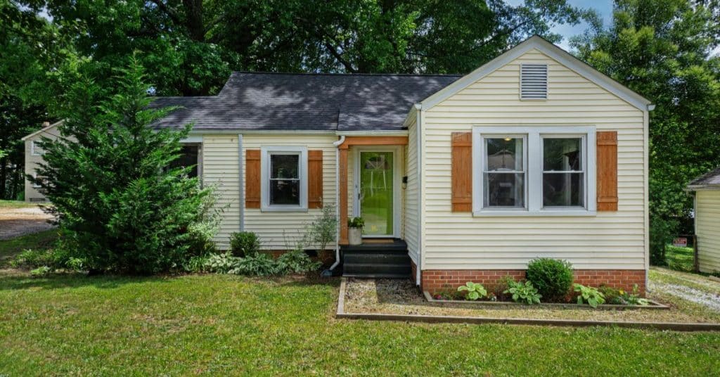 Split level home exterior before renovation showing outdated design and layout