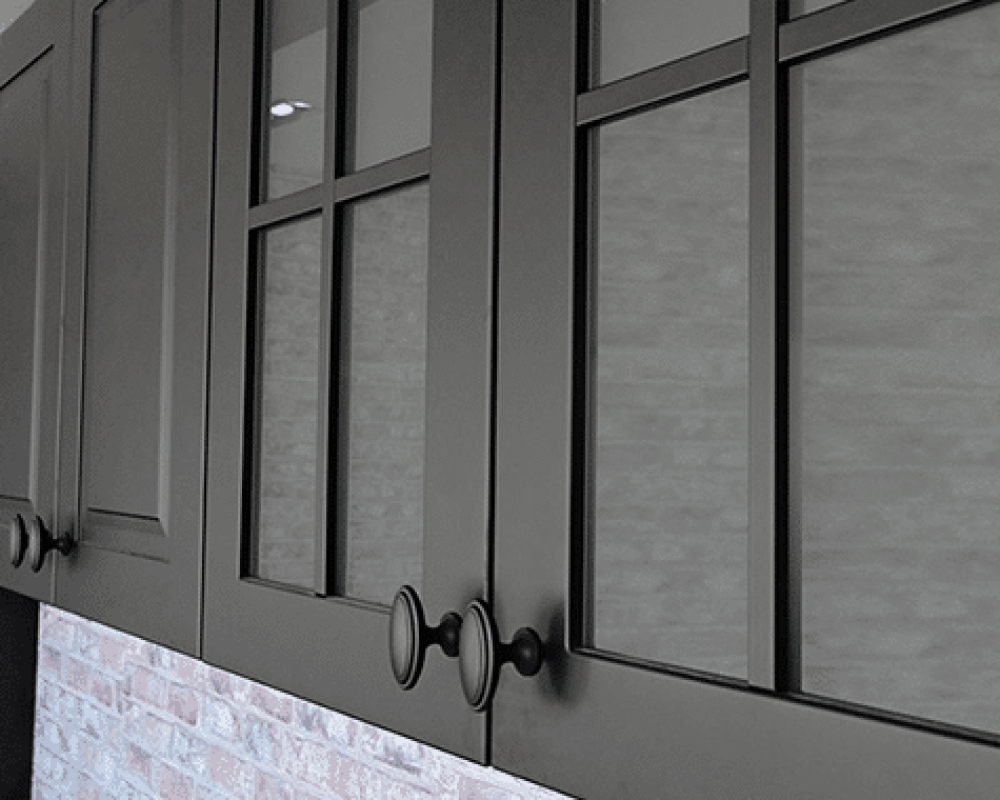 Close-up of matte black cabinet doors with modern black handles